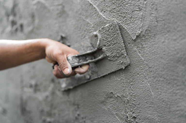hand-worker-plastering-wet-cement-wall-background-2023-08-19-05-47-52-utc